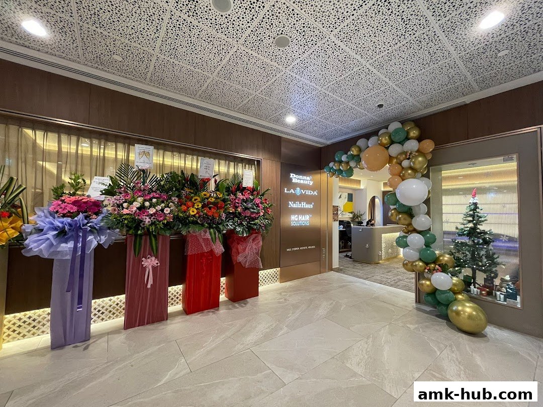 A shop entrance decorated with congratulatory flower stands and a balloon arch.