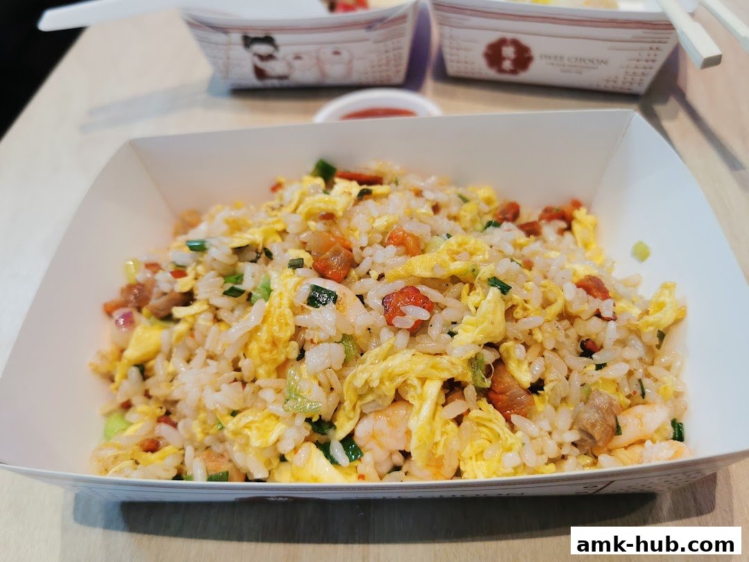 A close-up of a delicious fried rice dish with shrimp, egg, and char siu.