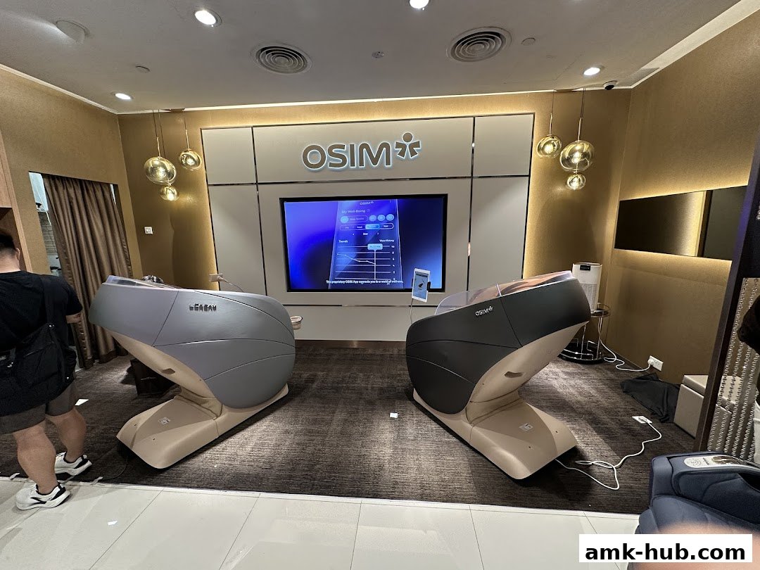 Two OSIM massage chairs are displayed in a modern retail store with a large screen.