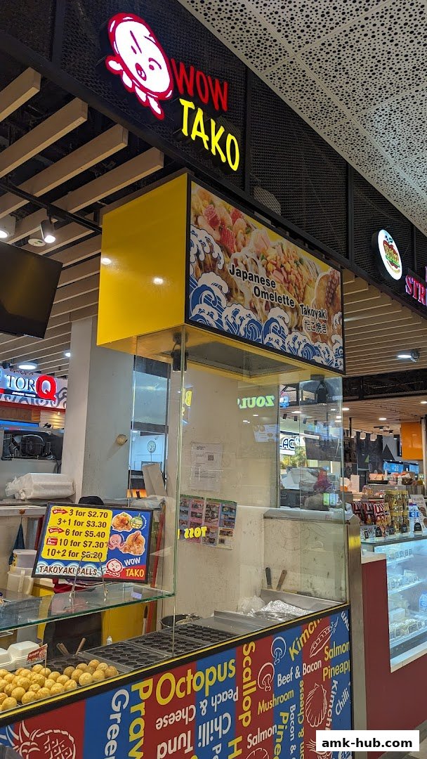 The Wow Tako shop front displays its logo, menu specials, and a variety of takoyaki flavors.