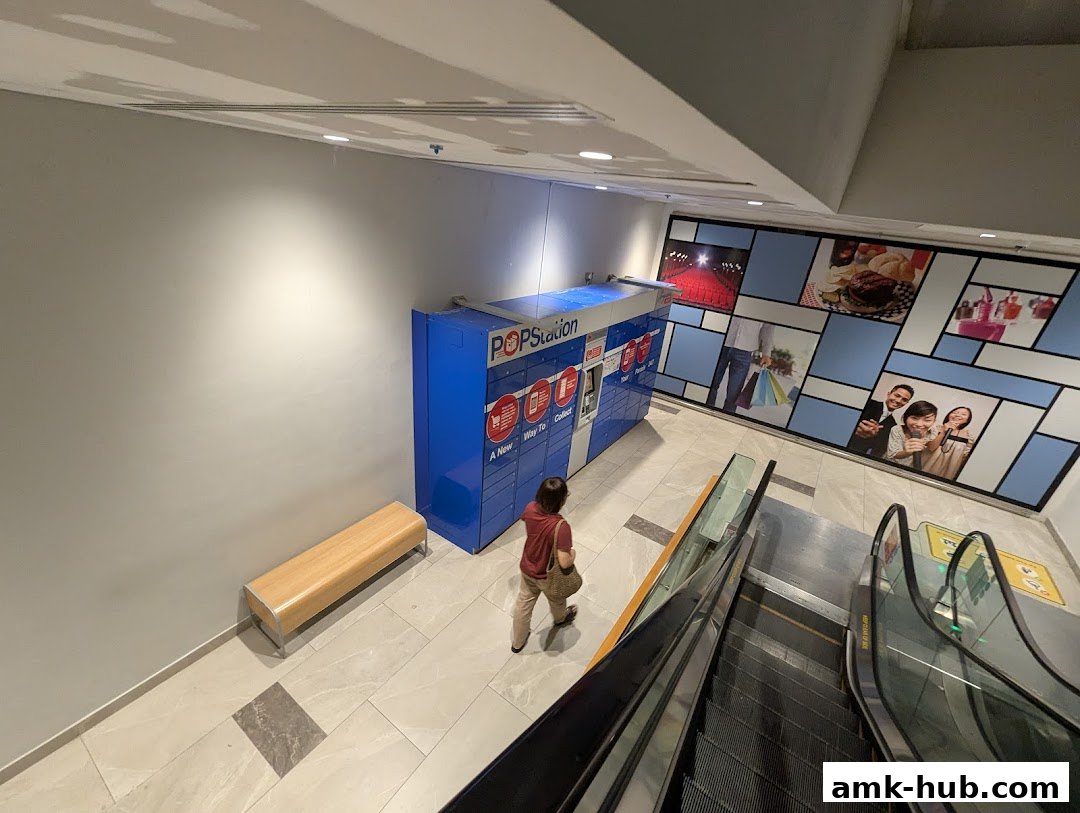 A POPStation locker unit is shown next to an escalator and a bench.