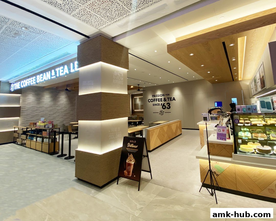 Interior view of The Coffee Bean & Tea Leaf shop with seating, counter, and display cases.