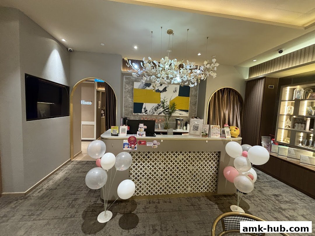 The reception area of a beauty salon with a counter, decorative lighting, and balloons.
