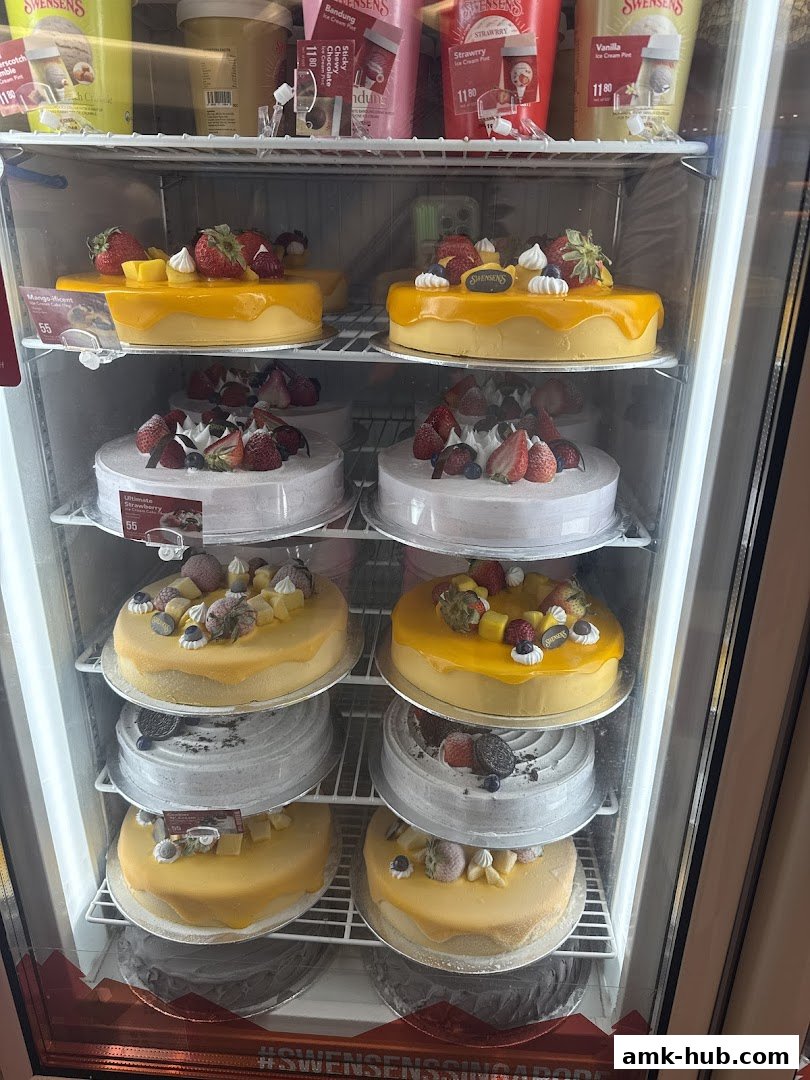 A display fridge filled with various cakes and ice cream pints from Swensen's.