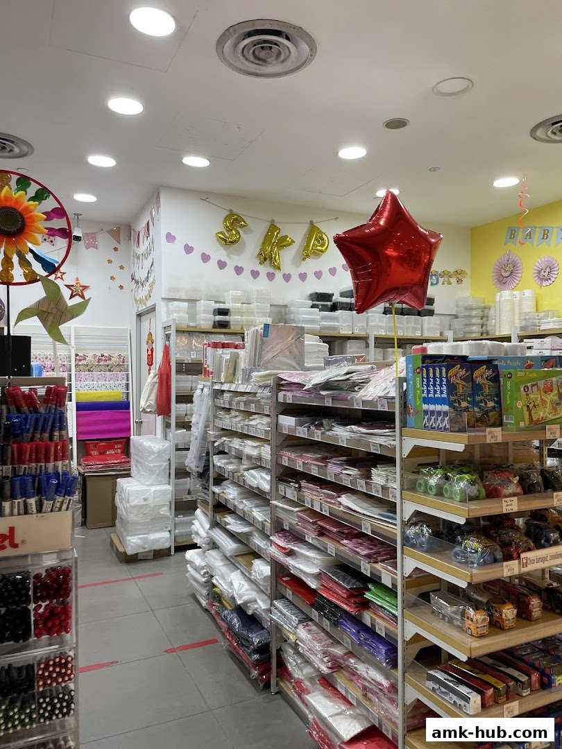 Interior view of a shop with shelves stocked with craft supplies, stationery, and toys.