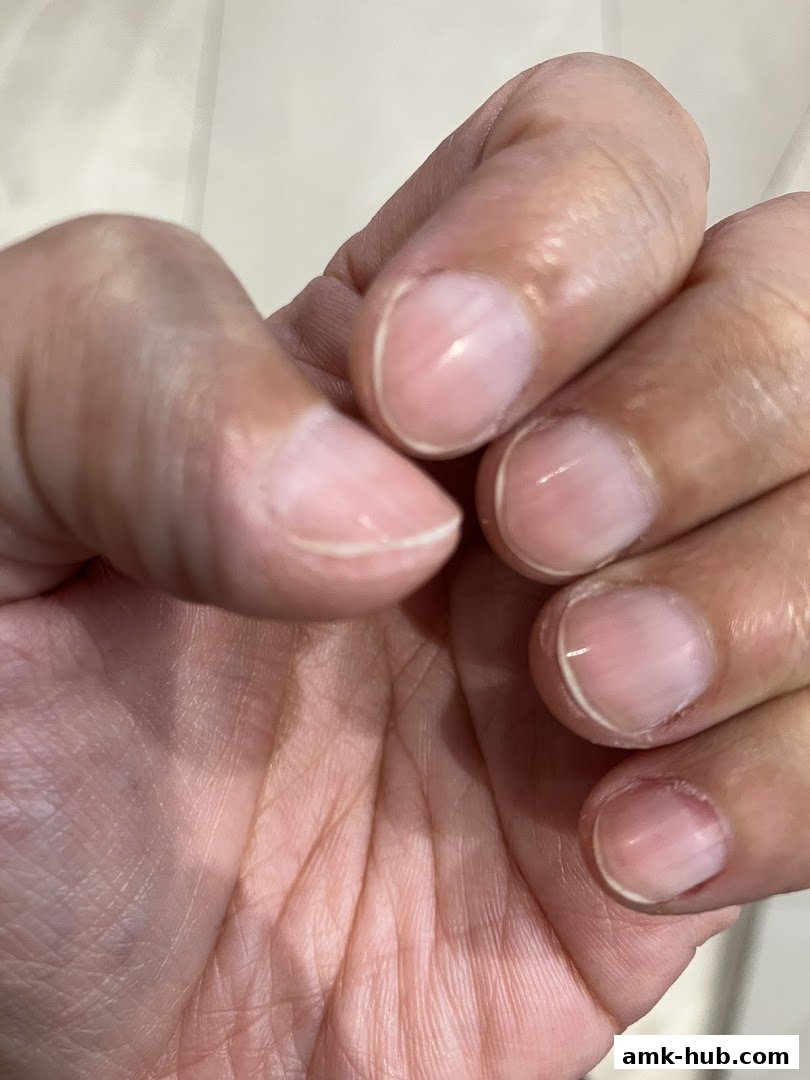 Close-up of a hand with neatly manicured, natural-looking nails.