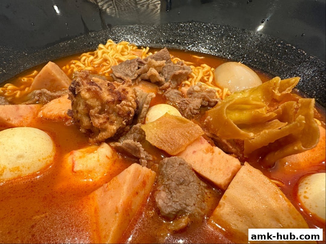 A close-up shot of a steaming bowl of Mala Tang with various ingredients.