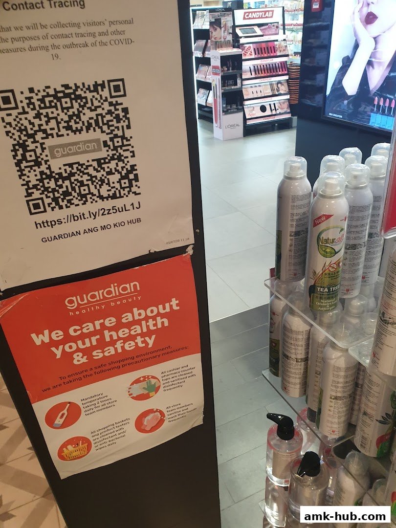 A Guardian store with health and safety information and various beauty products on display.