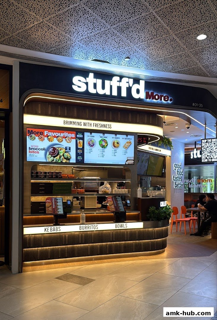 The Stuff'd More shop front displays a menu with various food options and a slogan about freshness.