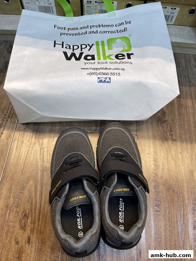 A pair of comfortable walking shoes and a Happy Walker branded shopping bag.