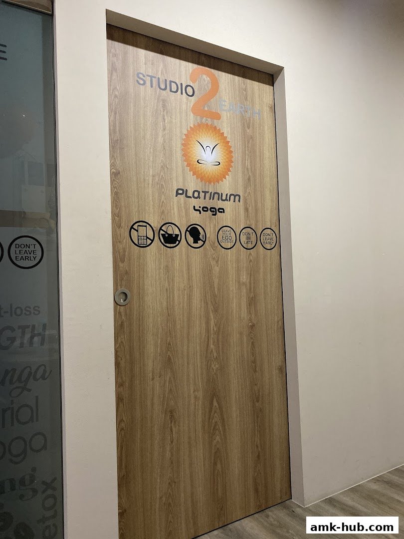 The entrance door to Platinum Yoga Studio 2 Earth, with various icons and rules displayed.