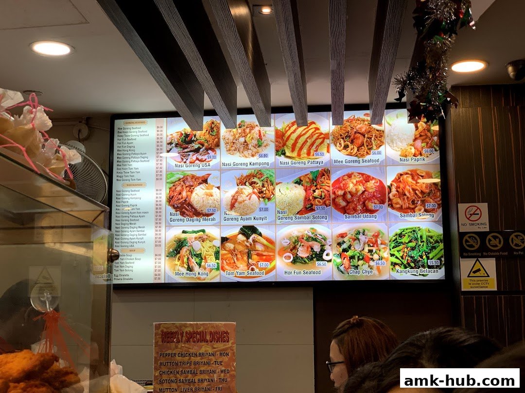 A brightly lit menu board displaying various Asian dishes with enticing food photography.