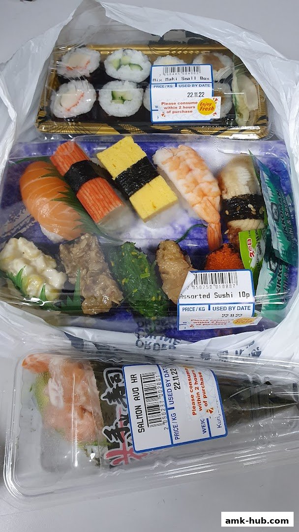 A selection of assorted sushi and maki rolls in plastic packaging, ready for purchase.