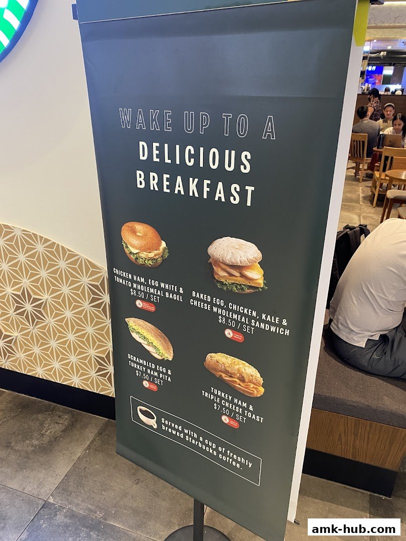 A Starbucks breakfast menu featuring sandwiches and bagels with prices.