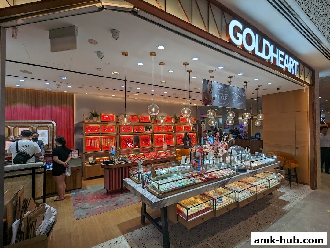 The exterior of a Goldheart Jewelry store with displays of necklaces and rings.