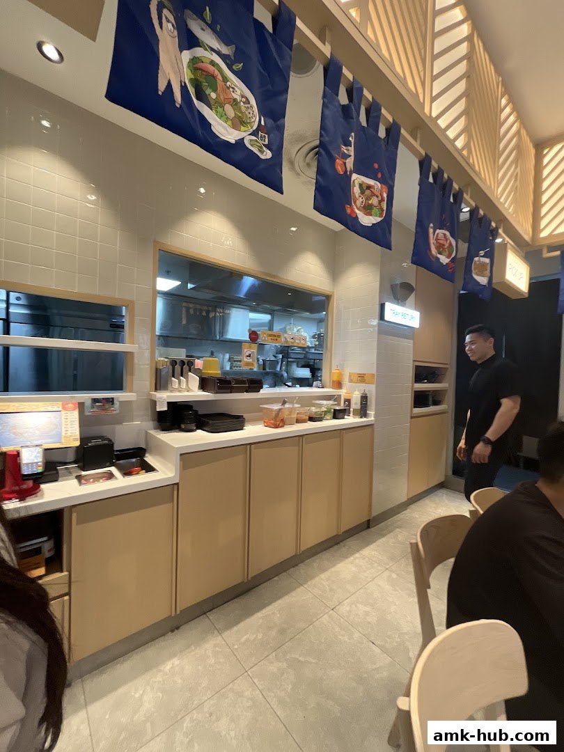 Interior view of Gong Yuan Ma La Tang with decorative banners and a serving counter.