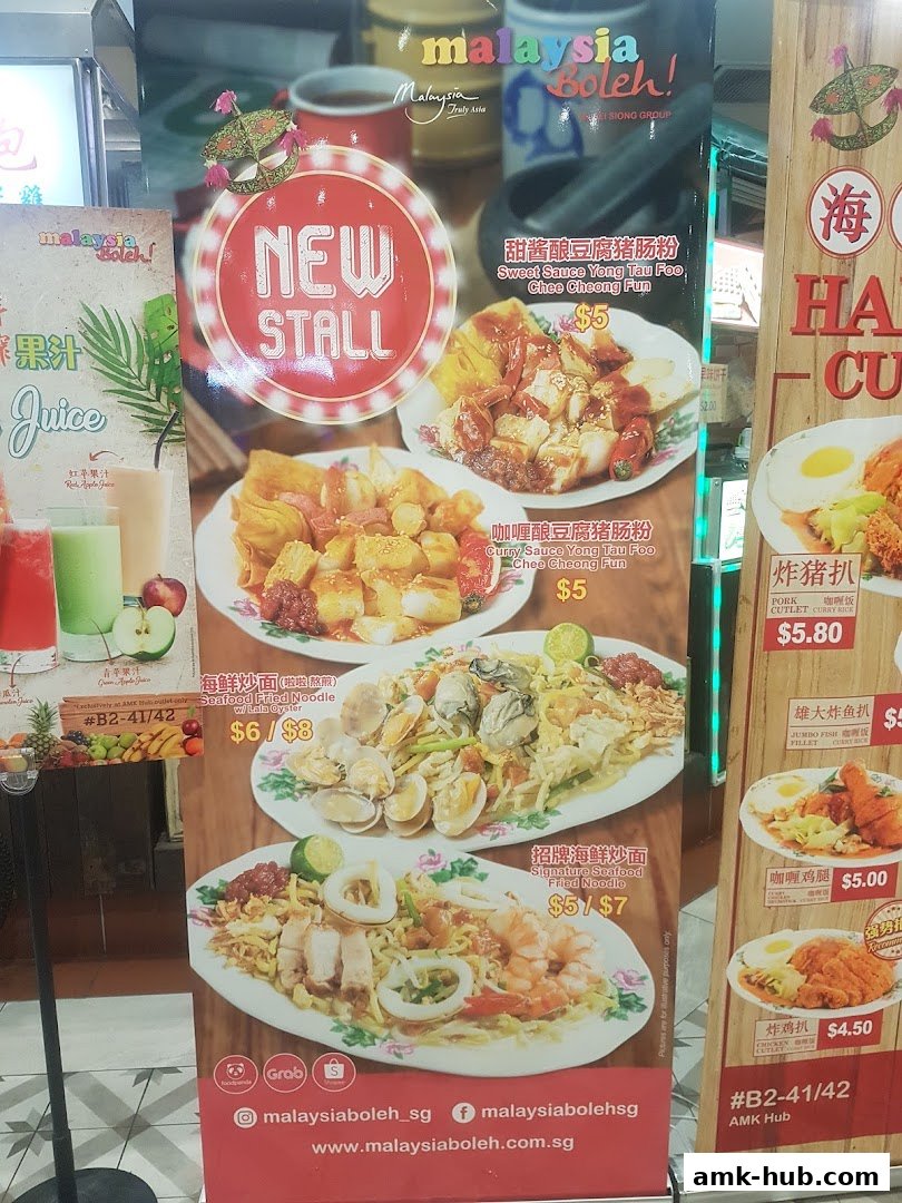 A menu board showcasing various Malaysian dishes with prices and images.