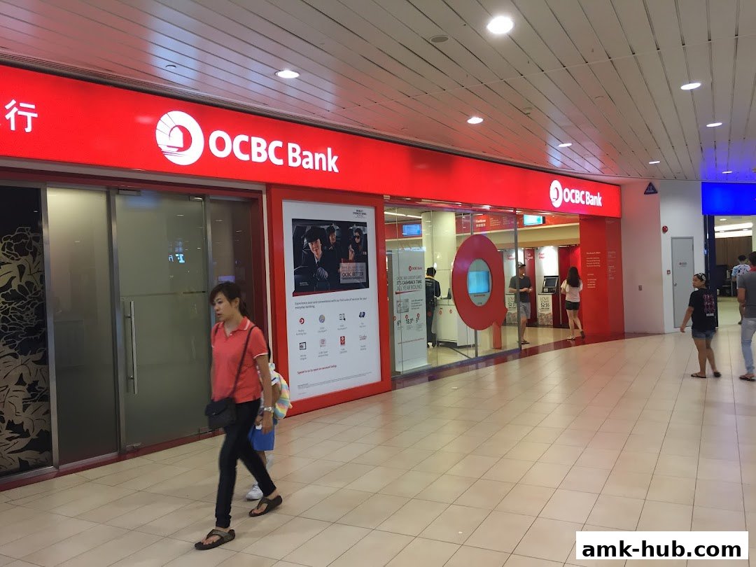 The exterior of an OCBC Bank branch with customers entering and exiting.