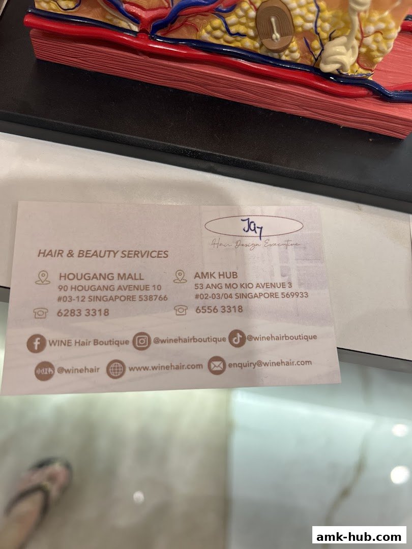 A business card for Wine Hair Boutique, detailing their services and contact information.