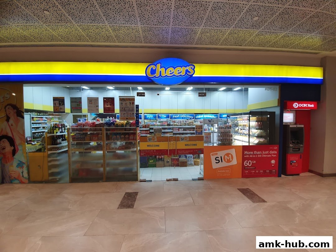 The exterior of a Cheers convenience store with a bright yellow and blue sign and an ATM.