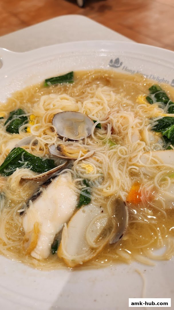 A close-up shot of a delicious seafood noodle dish with clams and fish.