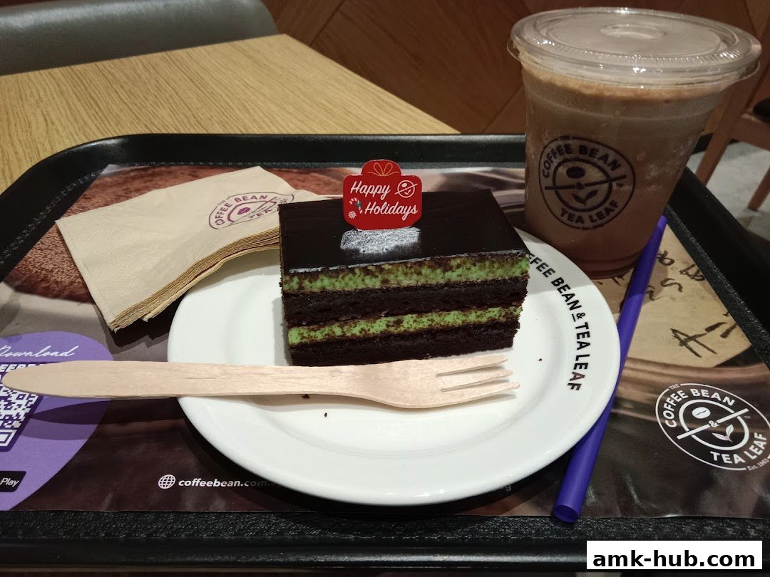 A slice of chocolate mint cake and a coffee drink on a tray at The Coffee Bean and Tea Leaf.