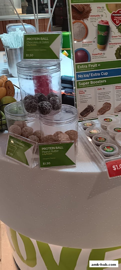 Boost Juice shop display featuring protein balls and menu items.