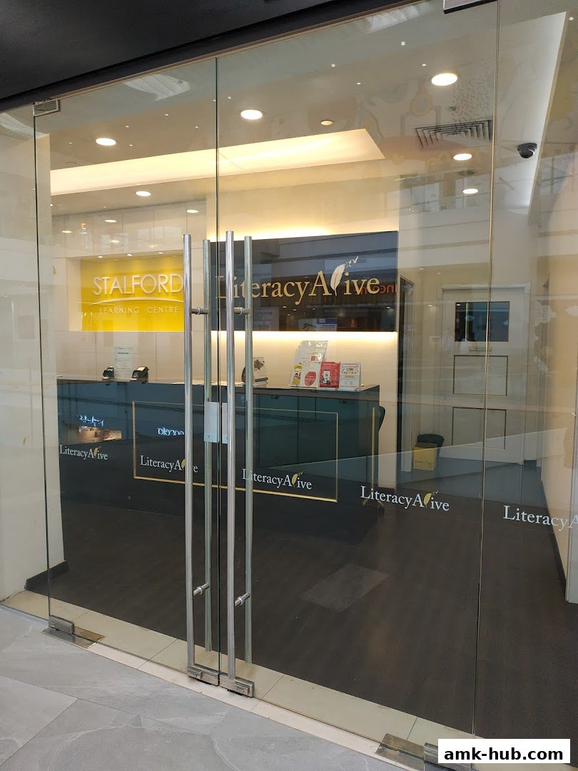 The entrance to Literacy Alive!, a learning center with glass doors and a reception area visible inside.