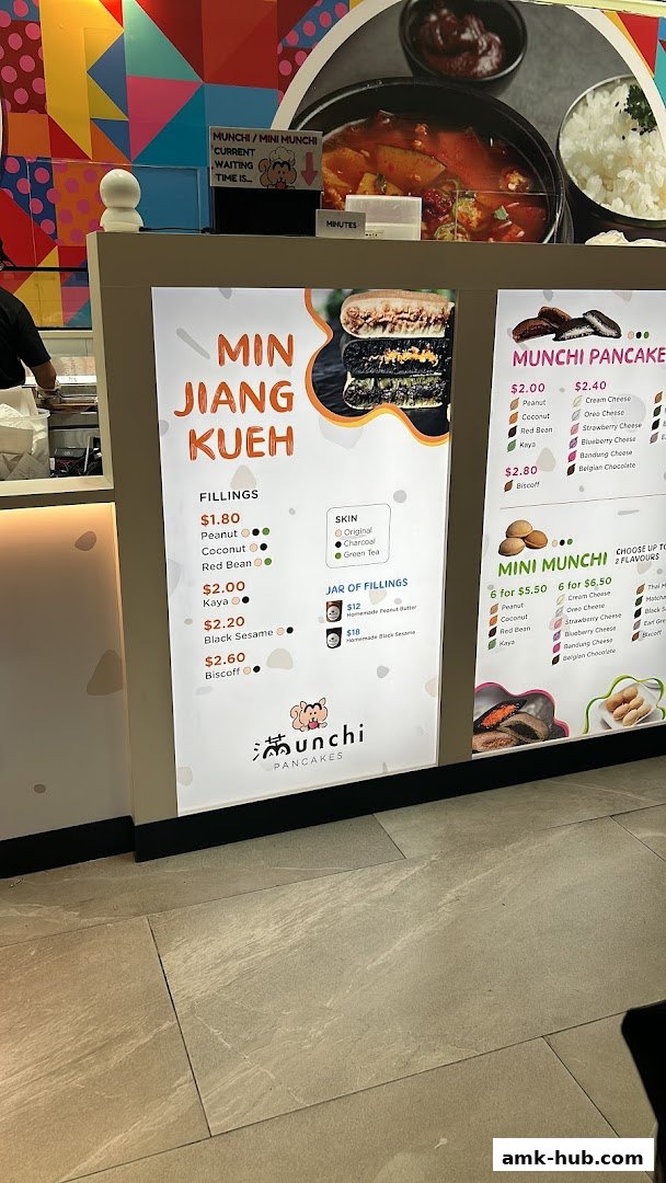 A menu board for Munchi Pancakes, showcasing various fillings and mini pancake options.