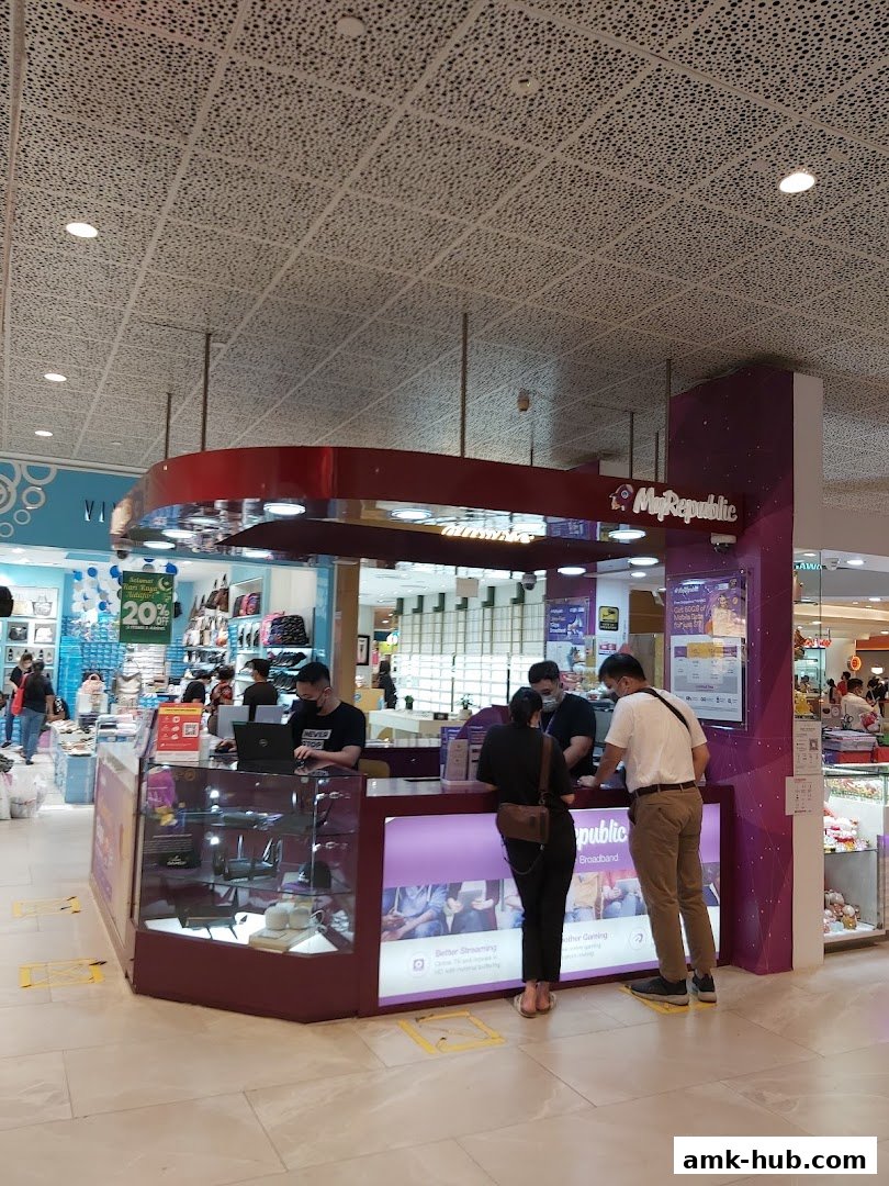 MyRepublic store counter with staff assisting customers and displaying broadband services.
