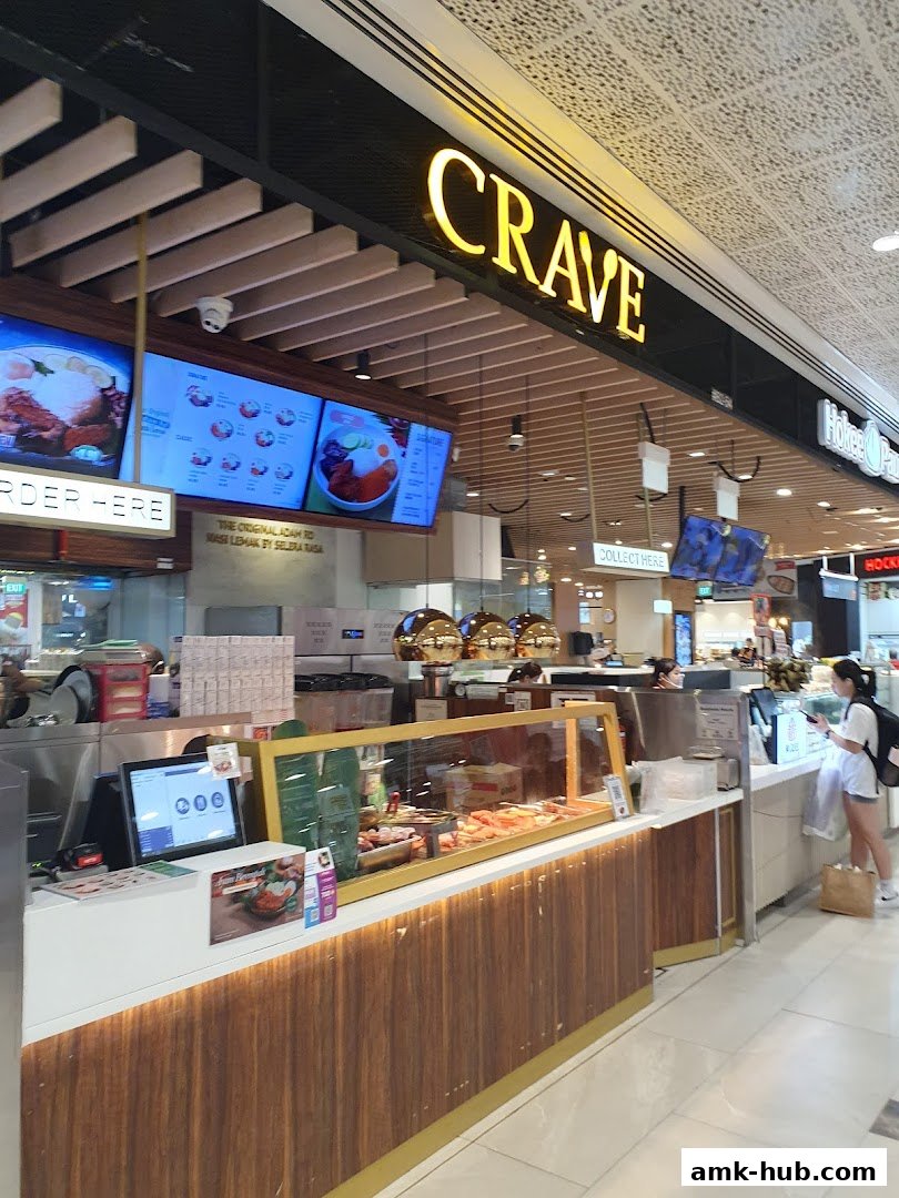 A food stall with a prominent 'CRAVE' sign and digital menus displaying food items.