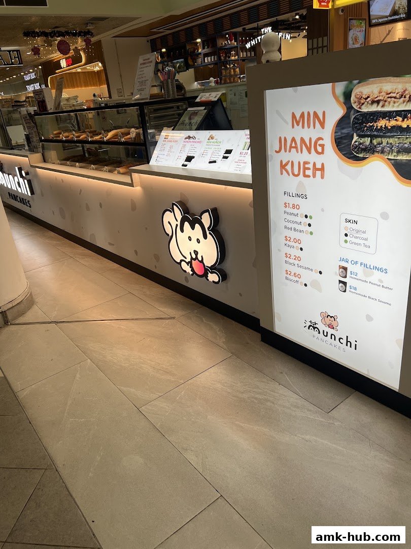 The Munchi Pancakes shop front with a menu display and various pancake fillings.