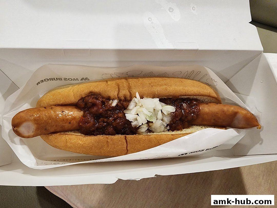 A delicious chili cheese hot dog from MOS Burger in a white box.