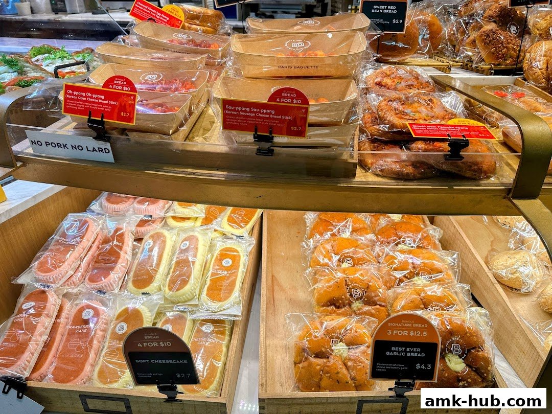 A display of various freshly baked breads and cakes at Paris Baguette.