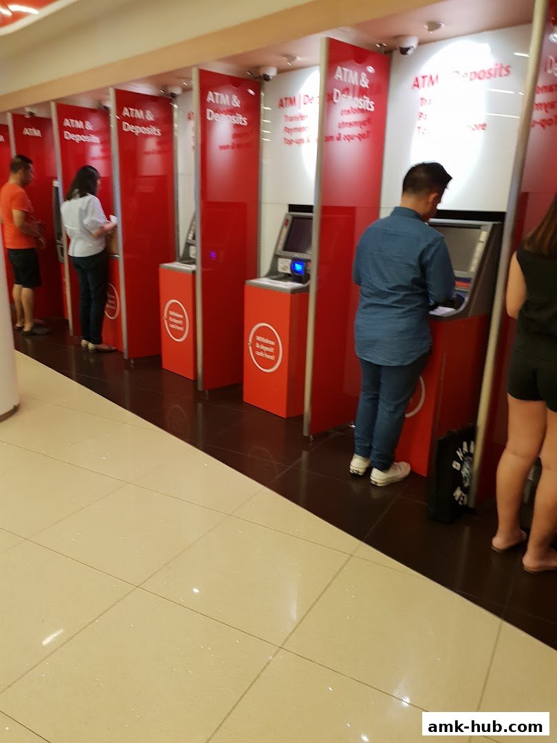 People using ATMs and deposit machines at OCBC Bank.