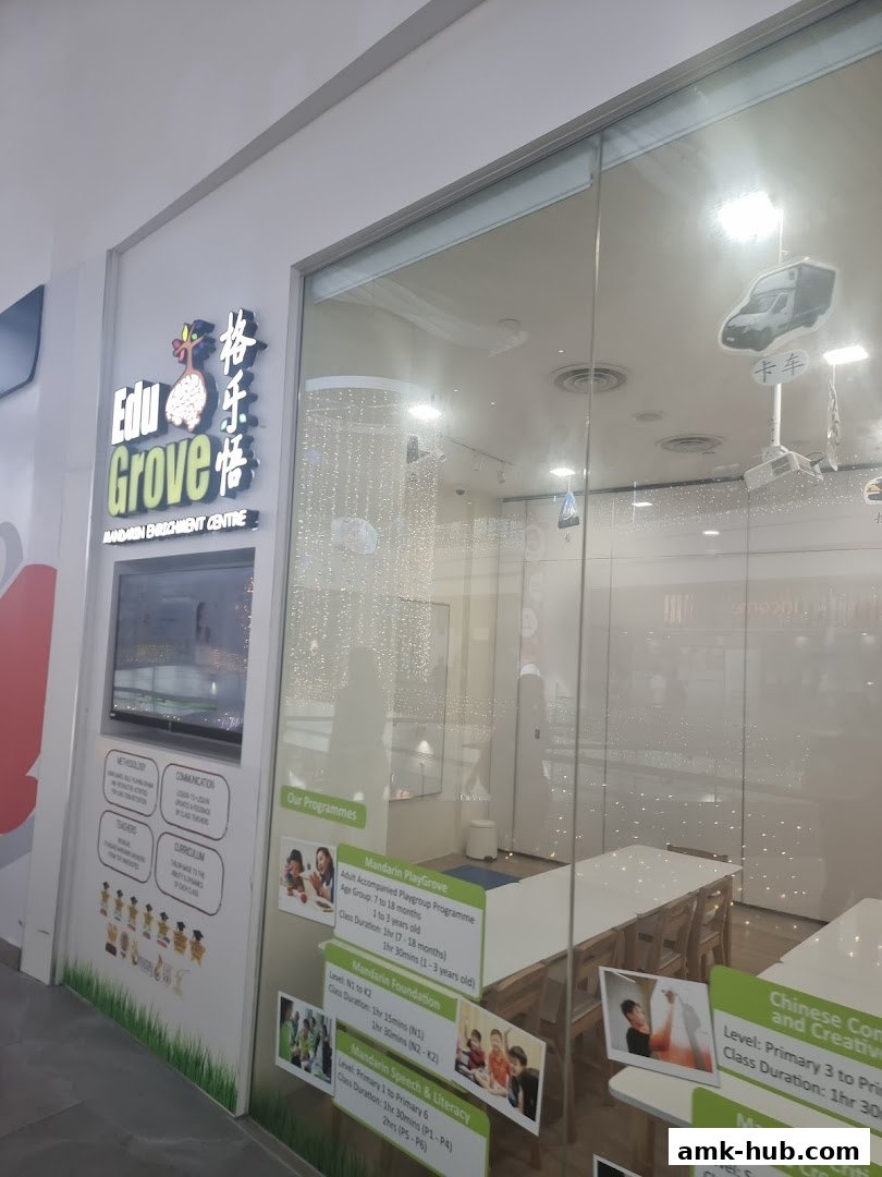 The entrance of EduGrove Mandarin Enrichment Centre with program details displayed.