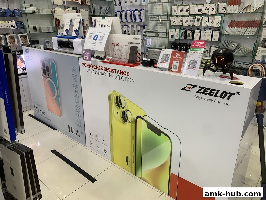 A retail shop counter displaying phone cases and accessories with promotional signage.