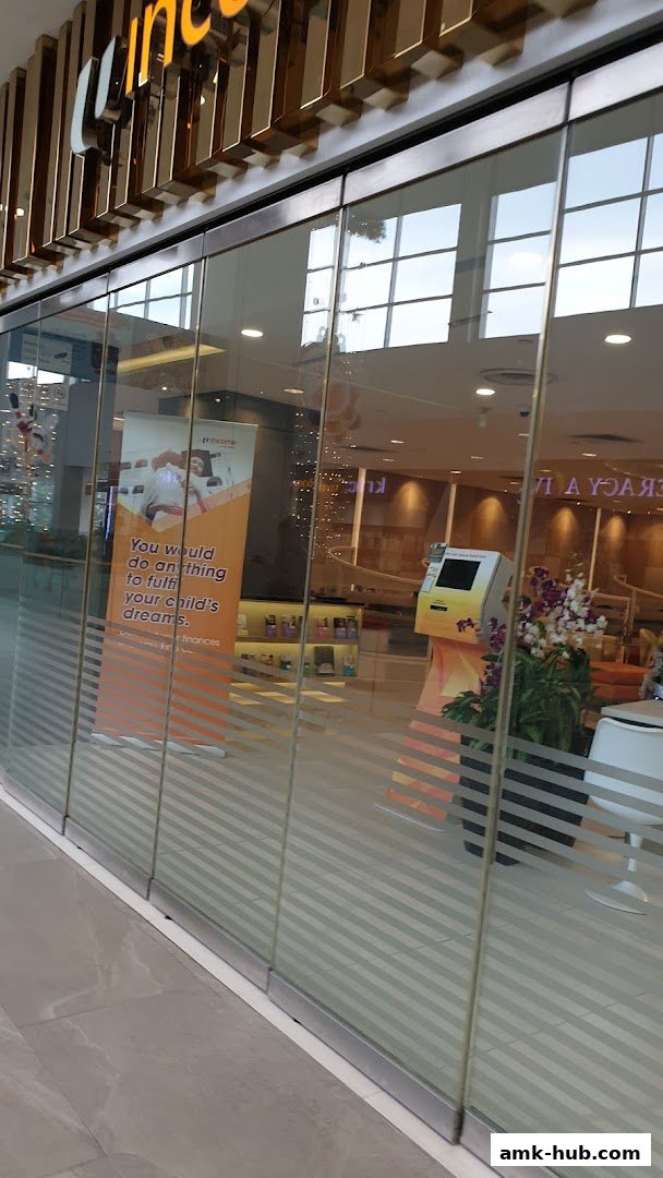 The exterior of the Income Insurance Ang Mo Kio Branch with a promotional banner inside.