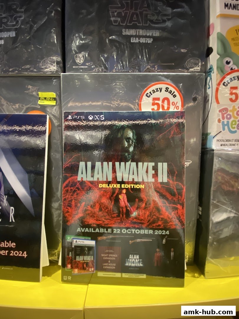 A display of video games, including 'Alan Wake II Deluxe Edition', with a 'Crazy Sale 50%' sticker.