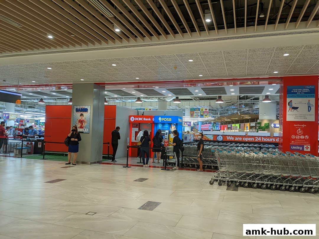 An OCBC ATM and POSB bank counter located inside a FairPrice Xtra supermarket.