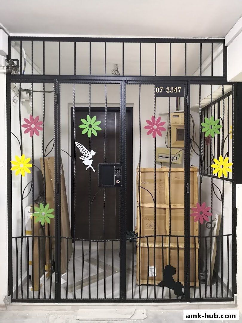 A black metal gate with colorful flower decorations and a digital lock.