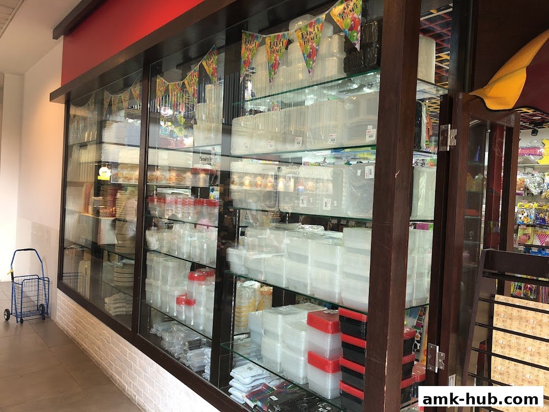 A shop display filled with various plastic containers and party supplies.