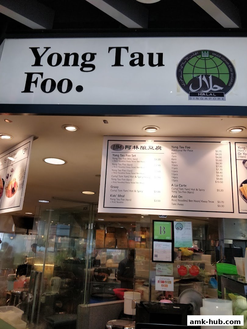 A menu board for Yong Tau Foo with various set meals and a la carte options.