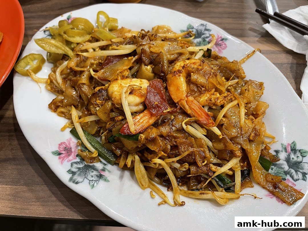 A plate of delicious Char Kway Teow with prawns and bean sprouts.