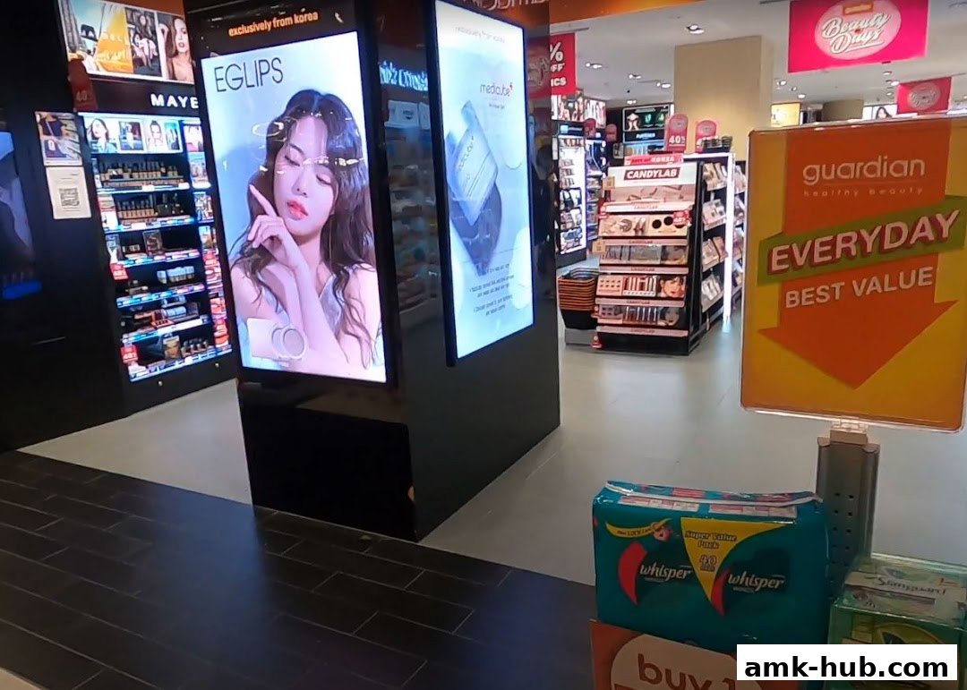 Interior view of a Guardian health and beauty store with product displays and promotional signage.