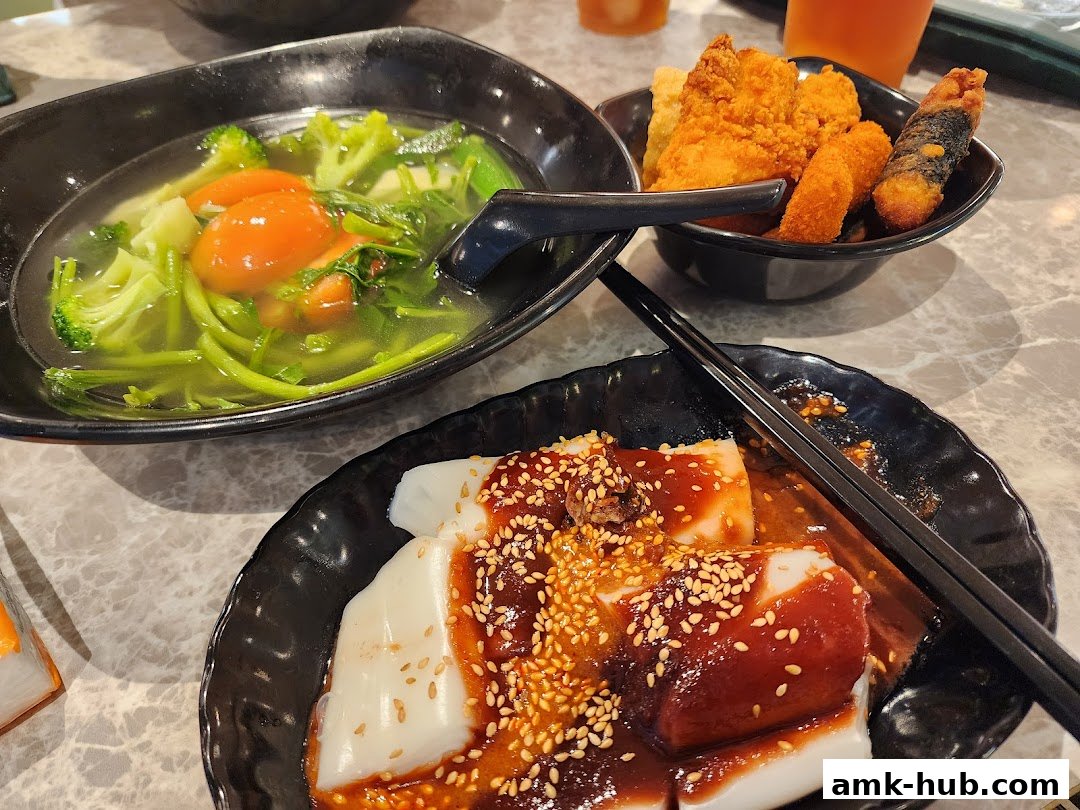 A close-up of delicious Yong Tau Foo dishes, featuring soup with vegetables and fried items.