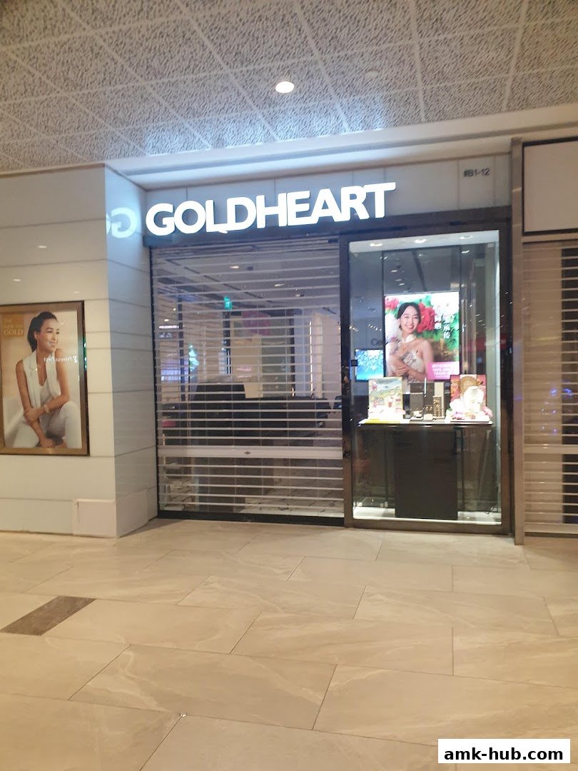 The Goldheart Jewelry store front with its illuminated sign and display window.