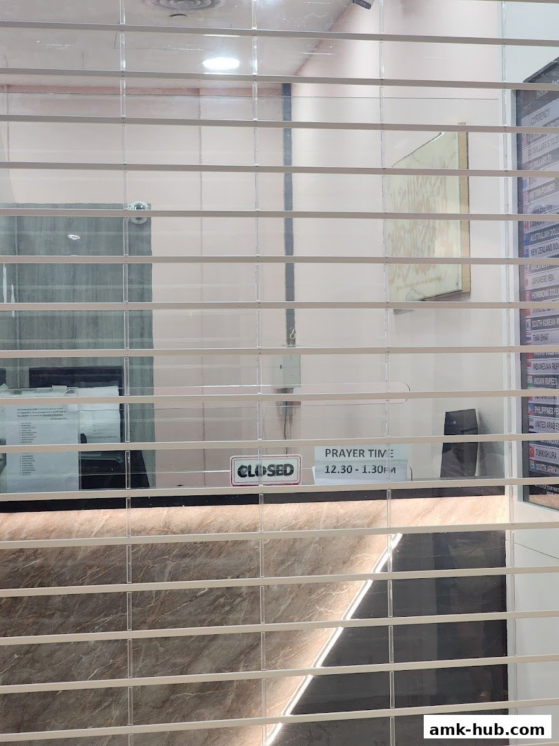 A shop counter with a 'Closed' sign and prayer time information.