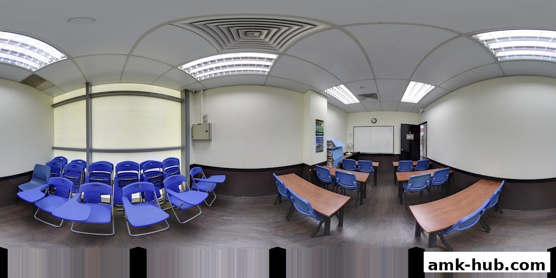 A classroom setting with blue chairs and tables, and a whiteboard on the wall.