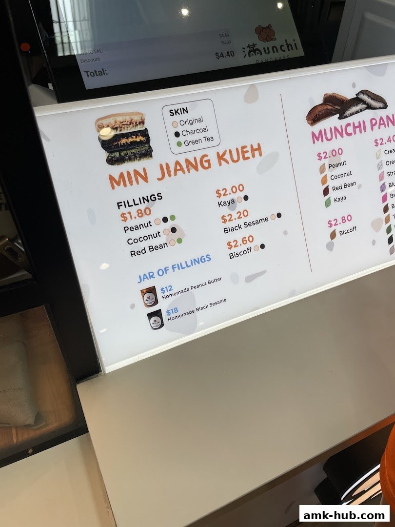 A brightly lit menu board displaying various pancake and filling options at Munchi Pancakes.